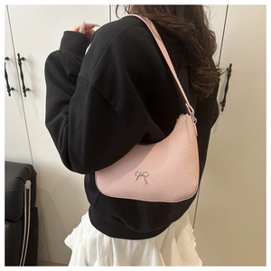 Pink underarm bag with silver bow detail and textured faux leather for women