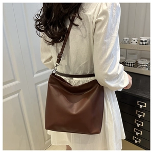 Detail view of large dark brown hobo tote bag with adjustable strap for daily commute