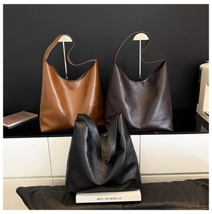 Detailed trio display of large minimalist tote bags in brown, dark coffee and black colors