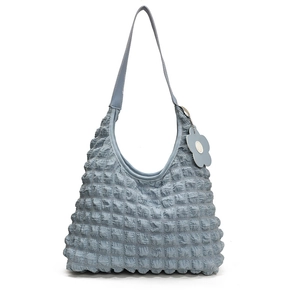Light blue shoulder bag with puckered bubble texture fabric and floral charm