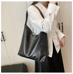 Large black tote bag with retro pleated texture leather shown on a shoulder