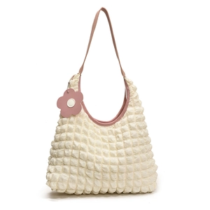 White popcorn texture bucket bag with pink leather trim and floral charm for women