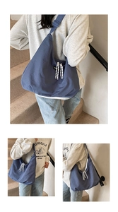 Detail of navy nylon tote bag with striped rope knot and adjustable webbing shoulder strap