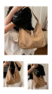 Detail view of khaki nylon tote bag with wide strap and striped ribbon decoration