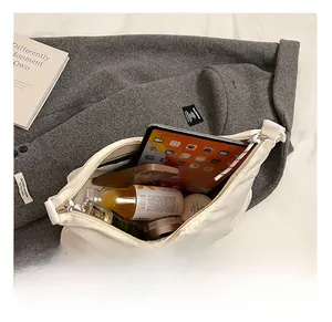 Interior view showing large capacity for iPad, phone, and makeup in a canvas tote bag