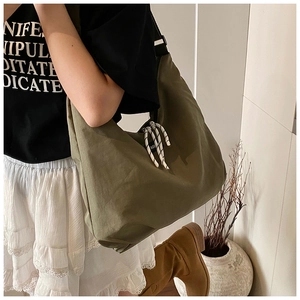 Detail of army green canvas hobo bag with thick cotton rope trim for casual daily use