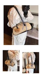 Detail of woven straw shoulder bag with black leather trim and plush bear charm
