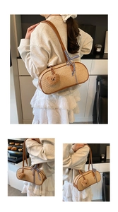 Detail of woven straw shoulder bag with leather straps and cute plush bear charm