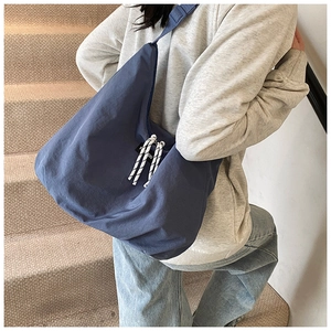 Close-up of durable navy blue canvas fabric with fashion label and braided zipper pull