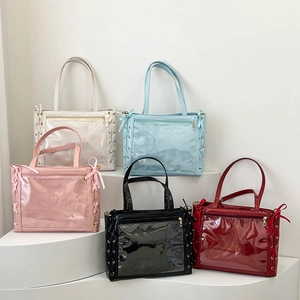 Five colors of ribbon ita bags with clear windows displayed on geometric stands