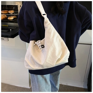 Detail of off-white crossbody bag featuring a fashion patch and woven checkered rope