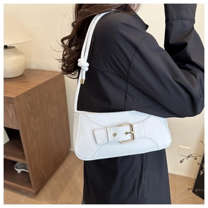 Detail of white PU leather underarm bag featuring a buckle design and knotted strap detail