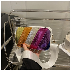 Detail of colorful metallic stripes and lychee grain texture on a leather crossbody bag