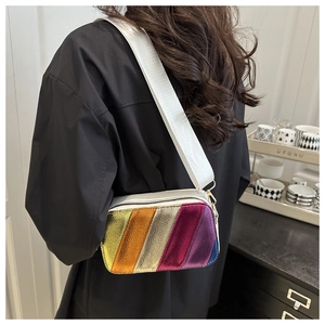 Close-up of metallic rainbow crossbody bag with a wide adjustable textile shoulder strap