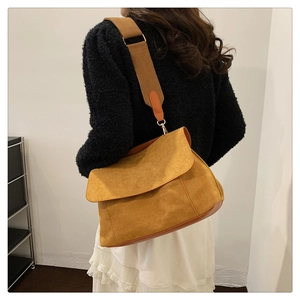 Detail of ginger yellow matte canvas tote bag with wide strap and gold metal buckle
