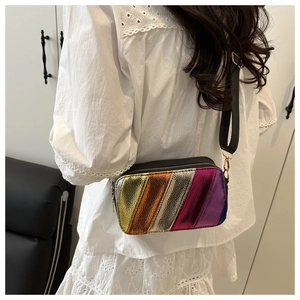 Rear view of a model wearing the rainbow metallic crossbody bag with wide strap