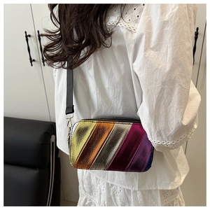 Detail of colorful metallic striped crossbody bag with wide black strap and gold hooks