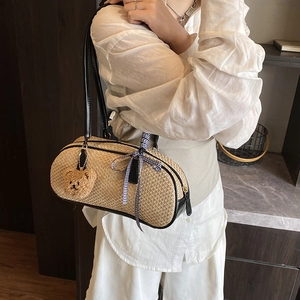 Minimalist woven straw shoulder bag with black leather handles and cute bear charm decor