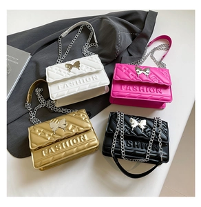 Detailed display of quilted crossbody bags with butterfly ornaments and metal chain straps