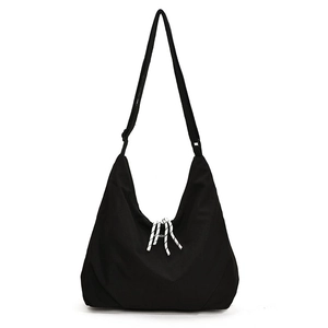 Minimalist black canvas crossbody bag with large capacity and decorative striped knot