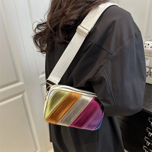 Rainbow stripe metallic crossbody bag with adjustable wide strap shown on model