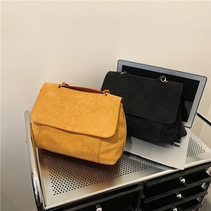 Faux suede crossbody bag set in yellow and black with gold ring hardware and flap design