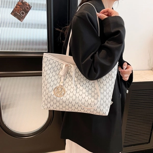 Chic off-white monogram tote bag with black M patterns and gold pendant for women