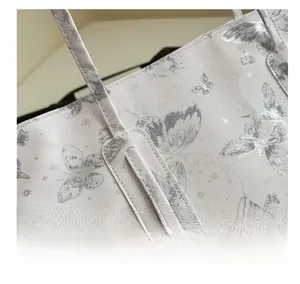 Close-up of reinforced stitching and butterfly print on twill fabric tote bag