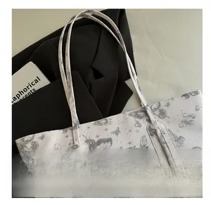 Detailed view of butterfly print canvas tote bag with reinforced stitching handles