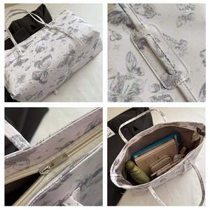 Detail showing butterfly tote bag with zipper closure and large internal storage space
