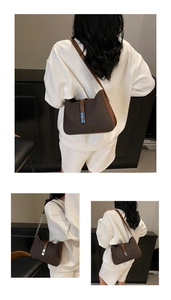 Detail of dark brown leather underarm bag featuring weave texture and silver buckle