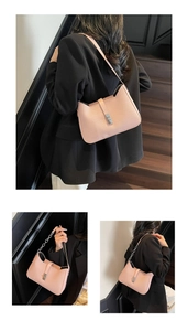 Pink woven texture shoulder bag featuring silver buckle and metal chain strap details