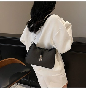 Detailed back view of a black cat-ear silhouette underarm bag with metal chain strap