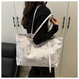 Detailed side view of large lavender tote bag with green butterfly and star prints