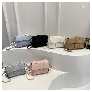 Detail shot of woven flap square bags in six colors with glossy synthetic leather
