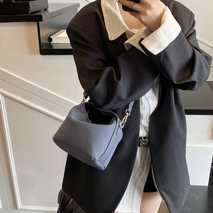 Chic blue textured bucket bag with slim shoulder strap for minimalist women's styling