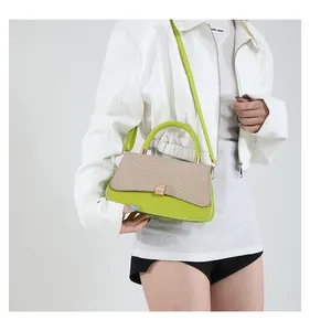 Detail of lime green mini crossbody bag with woven texture flap and gold metal clasp