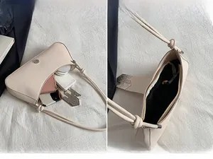 Detail view of the spacious main pocket holding daily essentials like a phone and lipstick