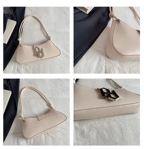 Detailed close-up of beige shoulder bag featuring geometric silver metal buckles