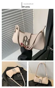 Detail of off-white leather shoulder bag featuring unique rope strap and silver metal buckle