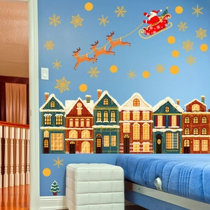Christmas wall decal set with hand-painted snowy houses and Santa reindeer on blue wall
