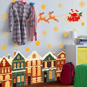 Christmas wall decal featuring Santa sleigh, reindeer, and snowy gingerbread houses