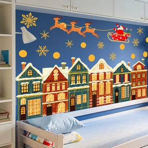 Christmas wall stickers with Santa, reindeer and colorful houses on a blue bedroom wall