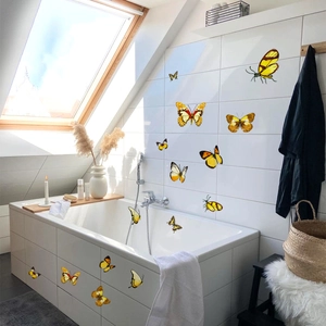 Detail of waterproof butterfly wall stickers in bright yellow on white bathroom tiles