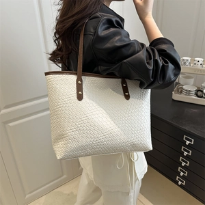 Minimalist large woven tote bag in cream white leather with contrasting brown straps