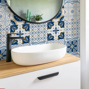 Detail of Mediterranean tile stickers with blue and yellow patterns in a bathroom setting