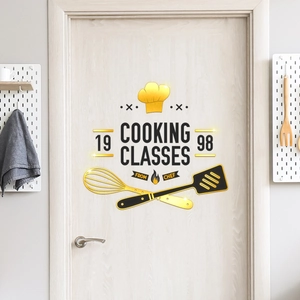 Primer plano de gorro de chef dorado y texto de clases de cocina en un vinilo decorativo