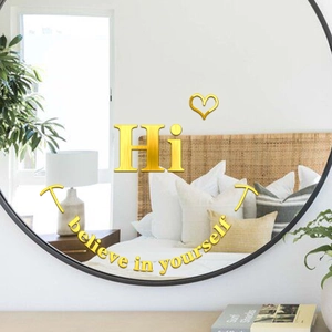 Gros plan de stickers muraux miroirs en acrylique doré avec texte 3D sur miroir rond