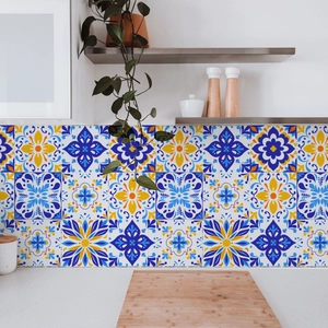 Detail of Mediterranean floral tile stickers on a kitchen wall with wooden kitchenware