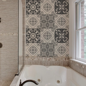 Vintage mandala grey and beige tile stickers applied on a bathroom wall over a tub